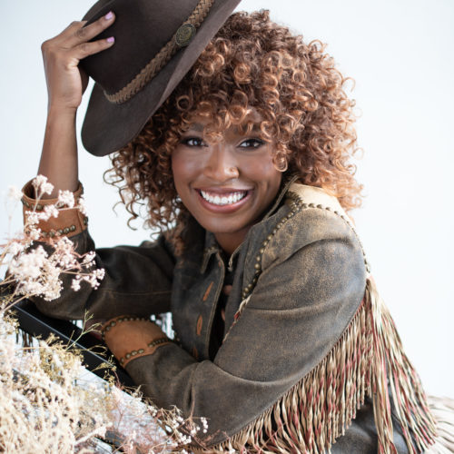 African American girl with fringe leather jacket and cowboy hat