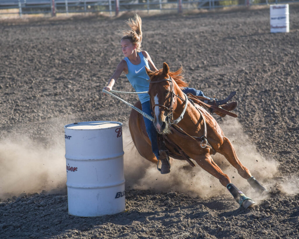 barrel racer bending around barrel